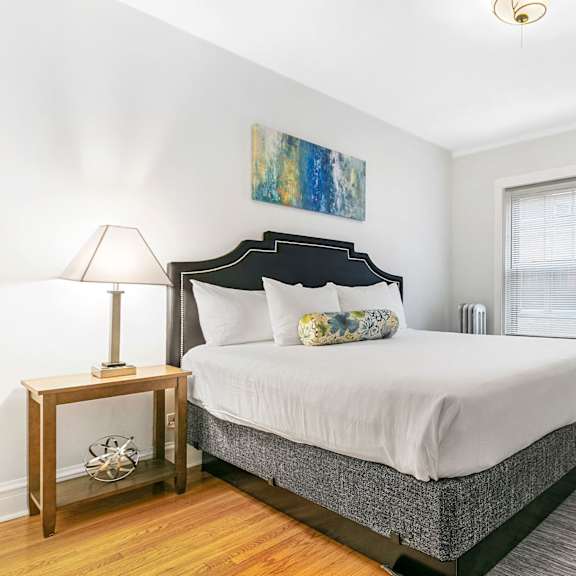 a bedroom with a bed and a mirror