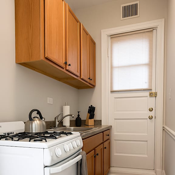 a white stove and oven in a kitchen with wooden cabinets.