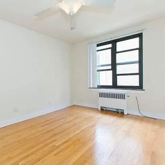 a room with a window and a radiator on the floor.