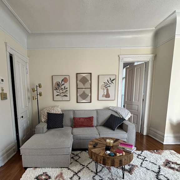 a living room with a grey couch and a coffee table.