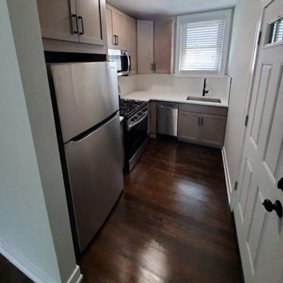 a small kitchen with a refrigerator and a sink