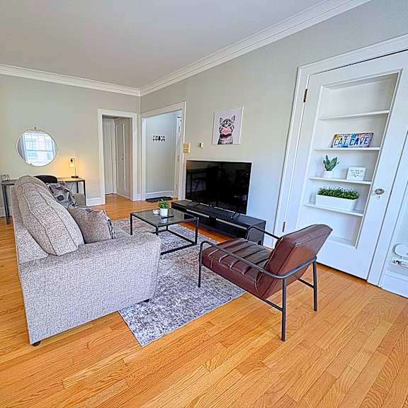 a living room with a grey couch and a brown chair.