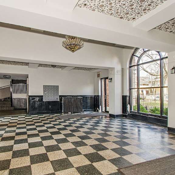 a lobby with a checkered floor and a large window