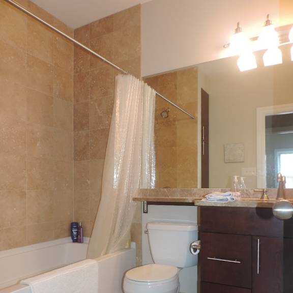 a bathroom with a toilet and a tub and a sink
