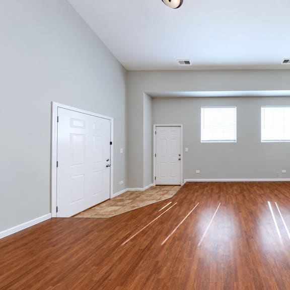 a room with wooden floors and white walls.