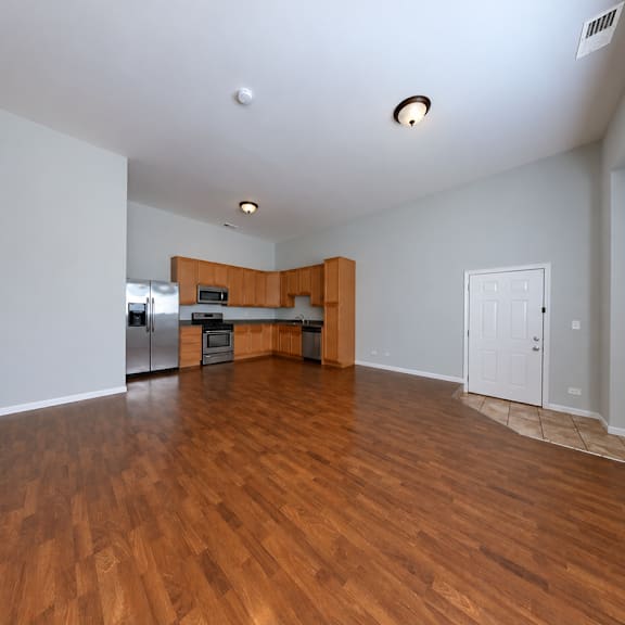 a large empty room with wooden floors and white walls.