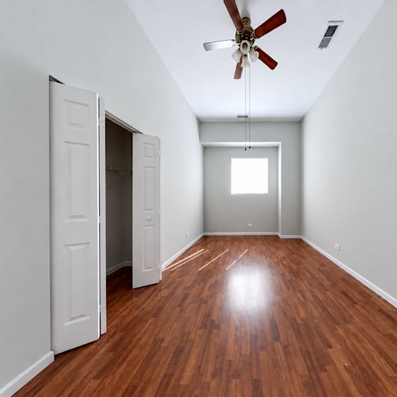 a room with a ceiling fan and a light switch.