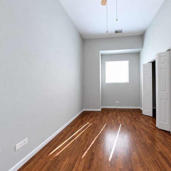a room with wooden floors and white walls.