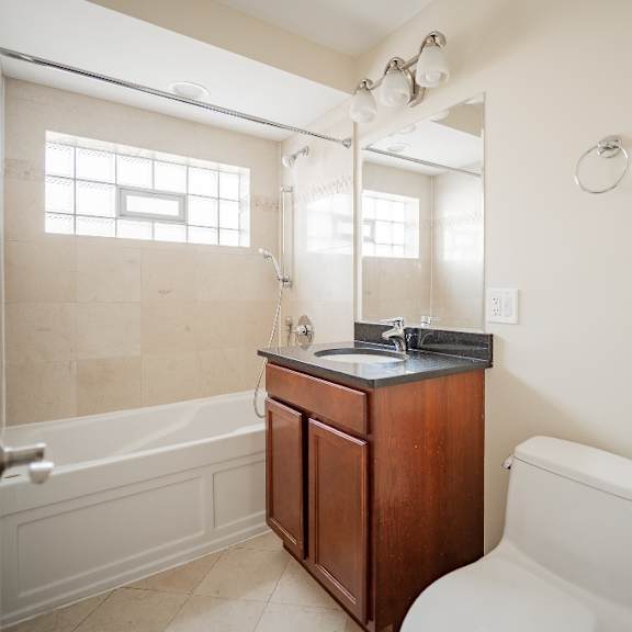 a bathroom with a toilet, sink, and bathtub.