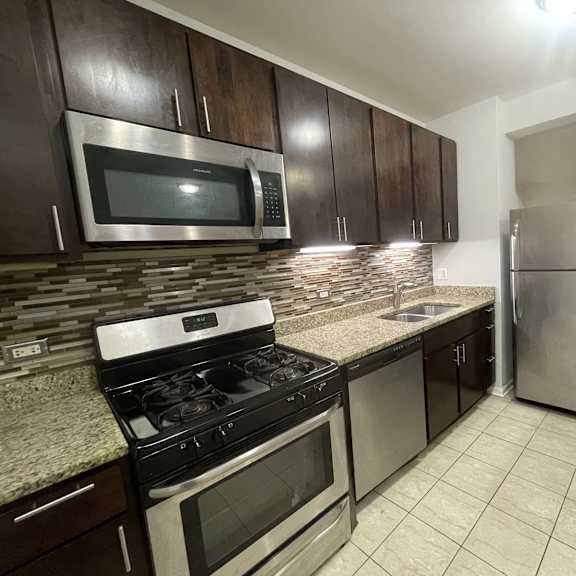 a kitchen with stainless steel appliances and granite countertops