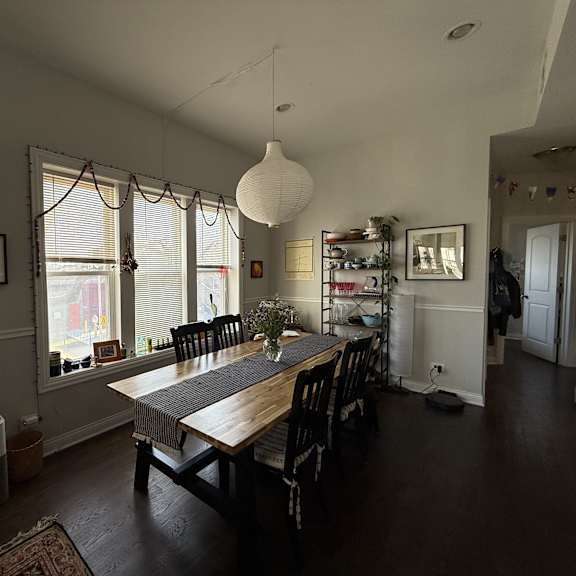 a dining room with a long table and chairs.