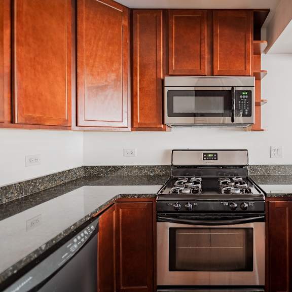 a kitchen with a black stove top oven and microwave above it.