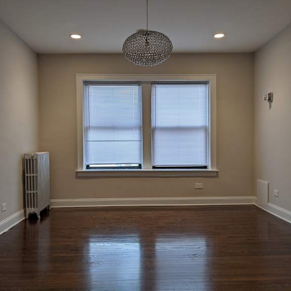 a room with a window and a radiator on the floor.