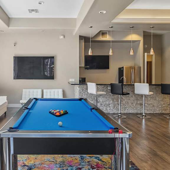 community clubhouse with game tables & kitchenette area at reserve at rancho apartments located in moreno valley, ca.