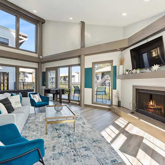 community clubhouse with lounge furniture and fireplace at seven lakes at carrollwood apartments in tampa, fl.