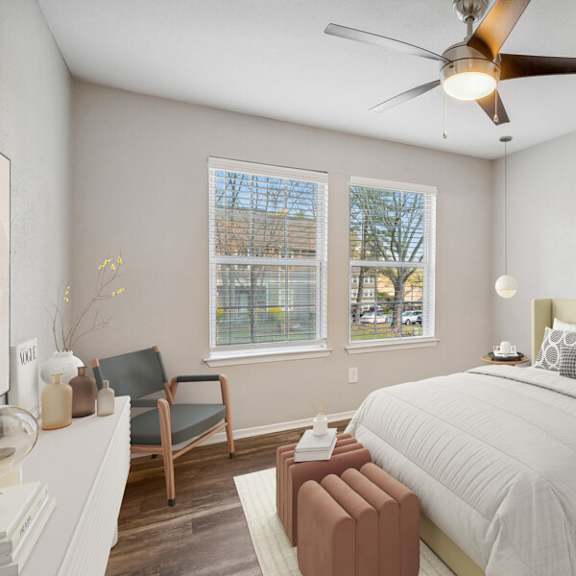 a bedroom with a large bed and a ceiling fan