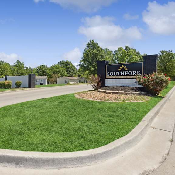property sign at entry at southfork mhc in belton, mo