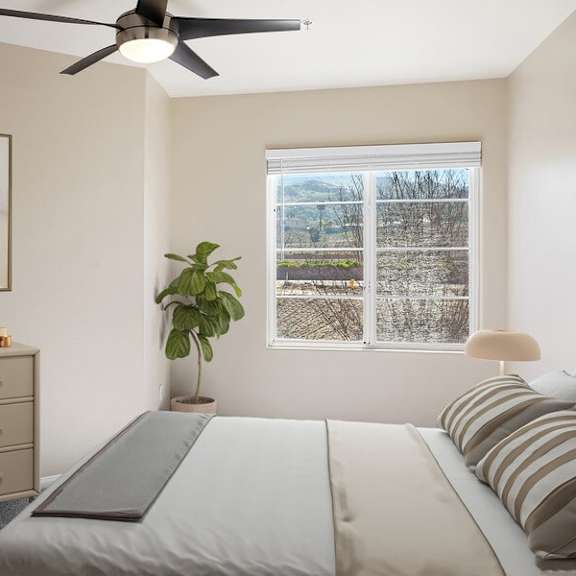 model bedroom with ceiling fan at reserve at rancho apartments