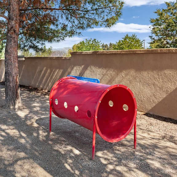 fenced dog park with agility equipment at reserve at rancho apartments