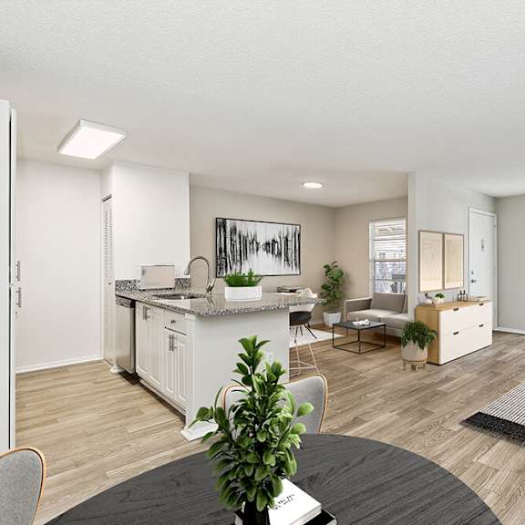 model living room and kitchen/dining room area with wood-style flooring at seven lakes at carrollwood apartments in tampa, fl.