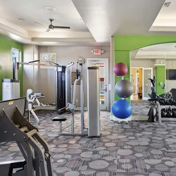 fitness center with weight lifting equipment at reserve at rancho apartments