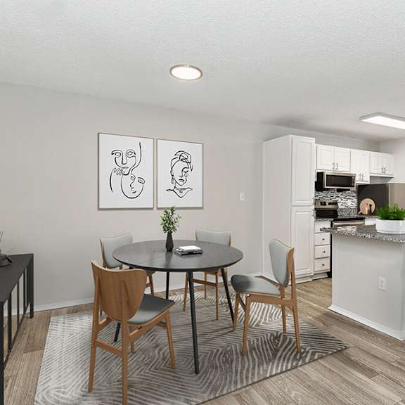 model dining room with wood-style flooring and view of kitchen at seven lakes at carrollwood apartments in tampa, fl.