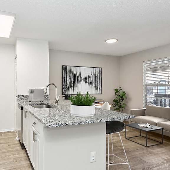 model kitchen with white cabinets and wood-style flooring at seven lakes at carrollwood apartments in tampa, fl.