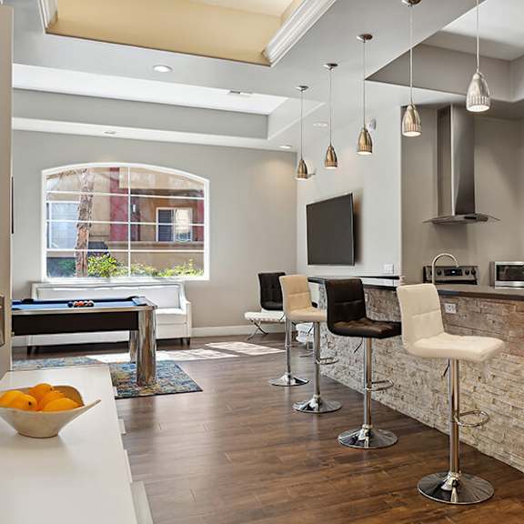 community clubhouse with kitchenette and pool table at reserve at rancho belago apartments in moreno valley, ca.