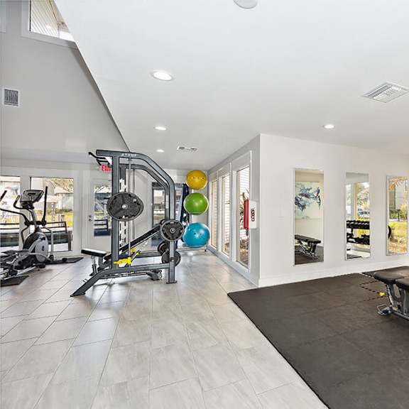 community fitness center with equipment at seven lakes at carrollwood apartments in tampa, fl.