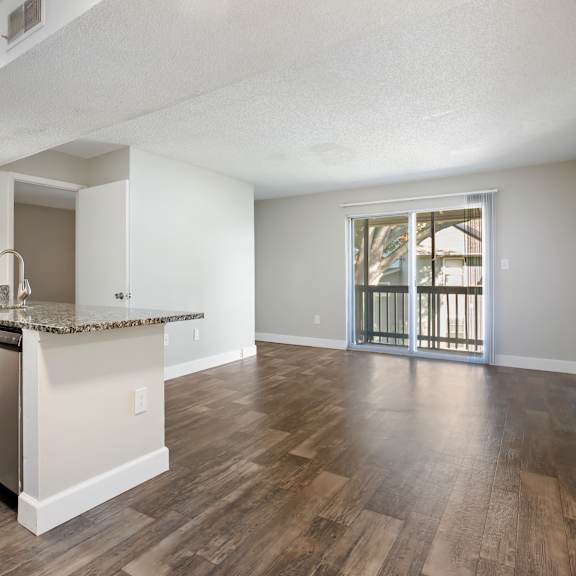 model living room with wood-style flooring at seven lakes at carrollwood in tampa, florida.