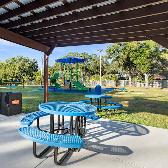 community pergola and picnic tables next to community playground at seven lakes at carrollwood in tampa, florida.