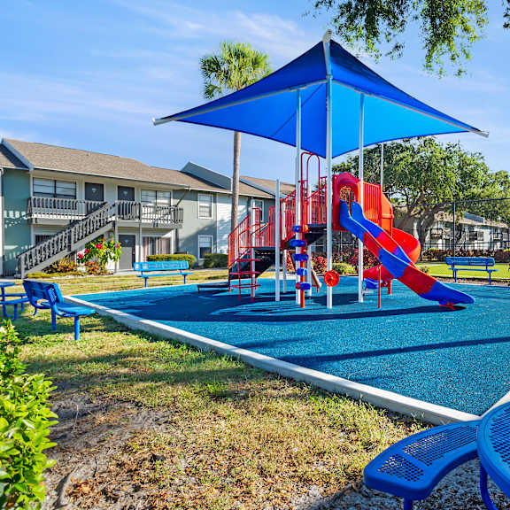 community playground and seating area at seven lakes at carrollwood in tampa, florida.