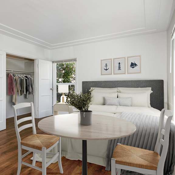 a bedroom with a bed and a table and a closet