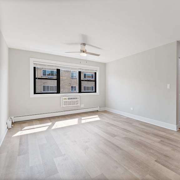 a bedroom with hardwood flooring and a ceiling fan