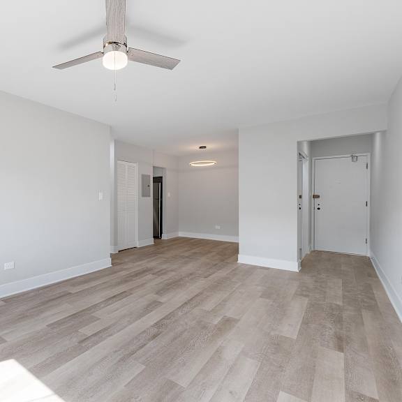 a bedroom with hardwood flooring and a ceiling fan