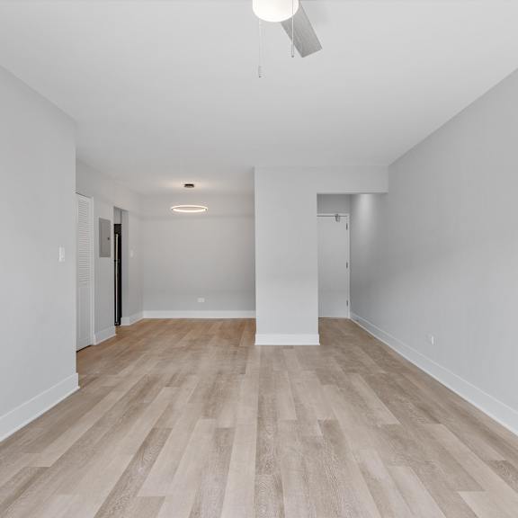 a bedroom with hardwood floors and grey walls
