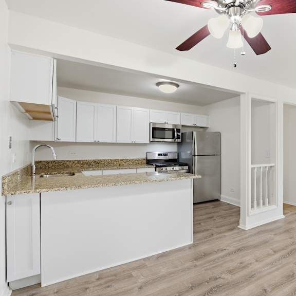 a kitchen with a counter and a fan.
