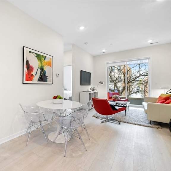 a dining room with a table and chairs and a living room