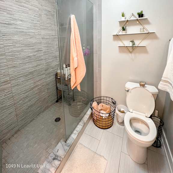 a small bathroom with a walk in shower and a toilet