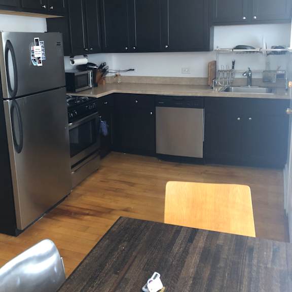 a small kitchen with a stove top oven and a sink.