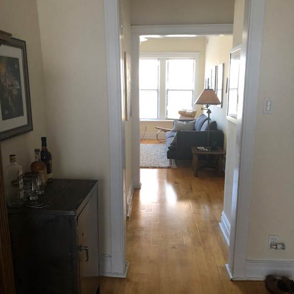 a room with a wooden wall and a window.