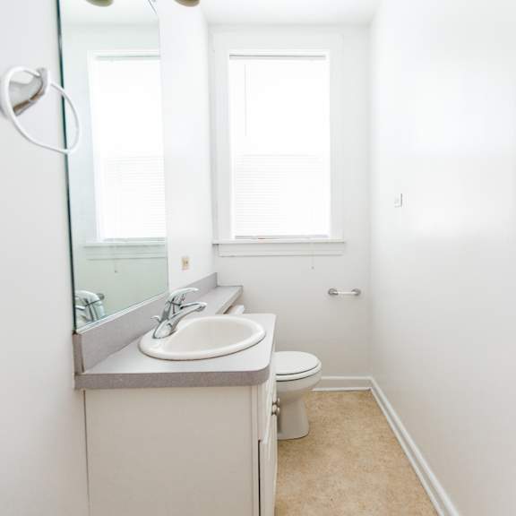 a bathroom with a sink and a toilet and a mirror