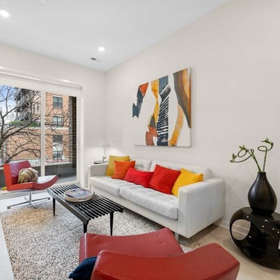 a living room with a white couch and a television