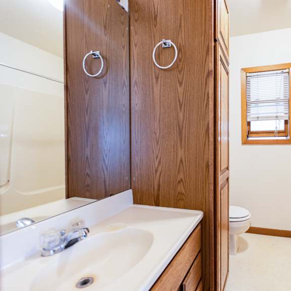 a bathroom with a white sink and a toilet.