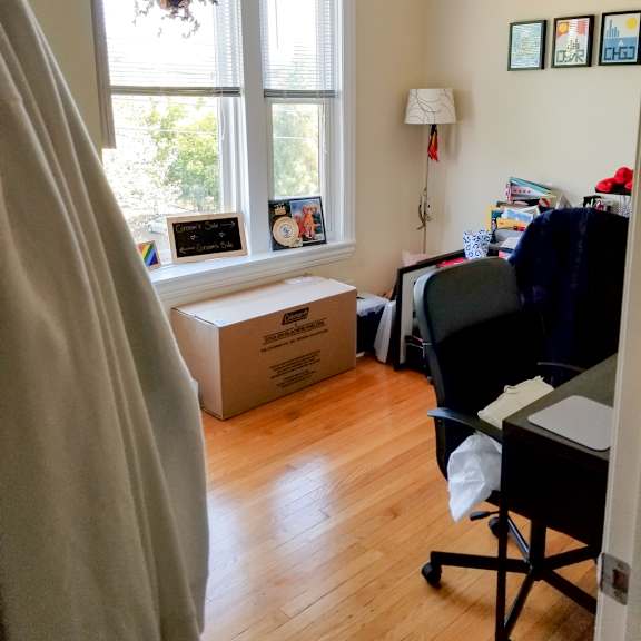 a room with a box on the floor and a window