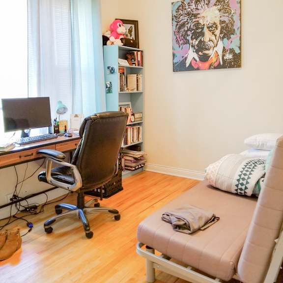 a bedroom with a desk and a futon     and a chair