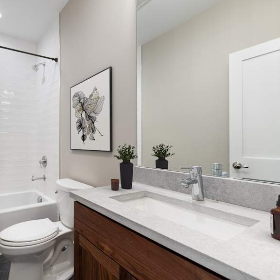 a white toilet sits next to a sink in a bathroom.