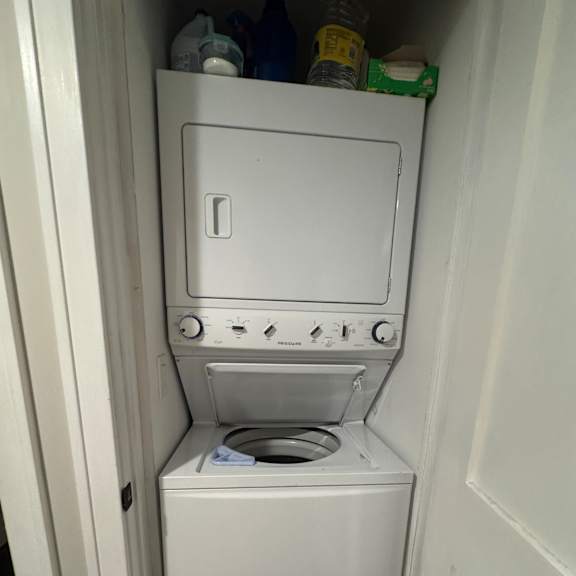 a white dishwasher and dryer are sitting on a shelf.