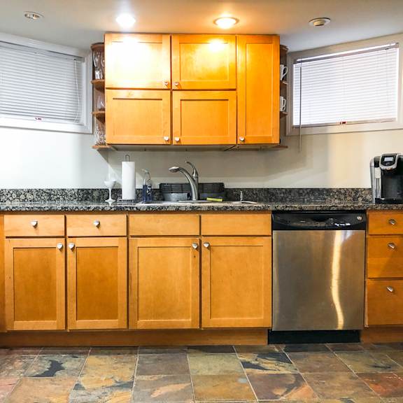 a kitchen with wooden cabinets and a tiled floor.