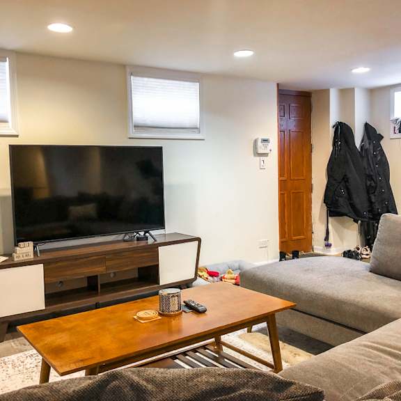 a living room with a television, a couch, and a coffee table.